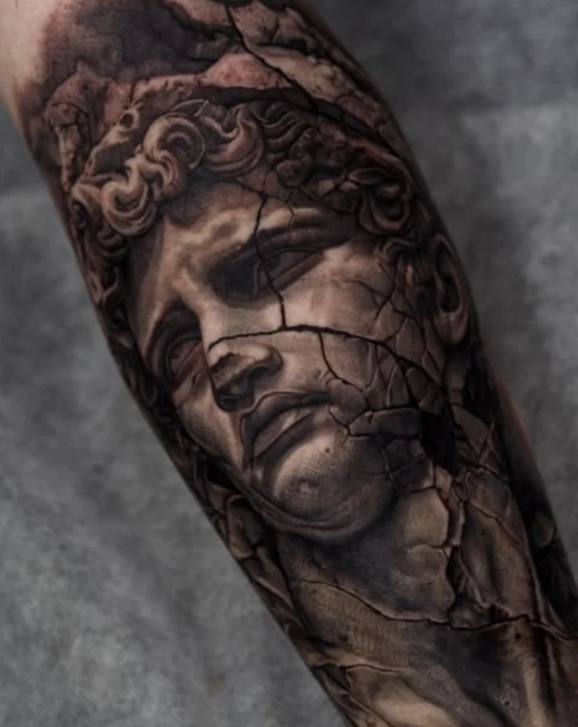 Hyper-realistic first tattoo design showing a classical statue with cracking effect, popular among Melbourne tattoo enthusiasts